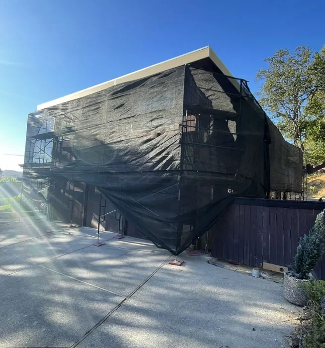 Full building scaffold wrap with protective debris netting by Glendale Scaffolding Rental