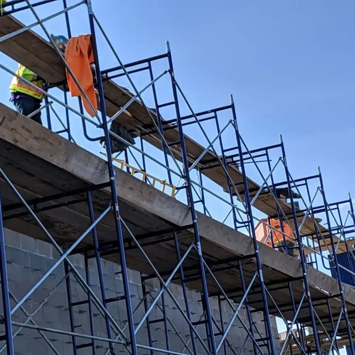Construction workers on frame scaffold by Glendale Scaffolding Rental