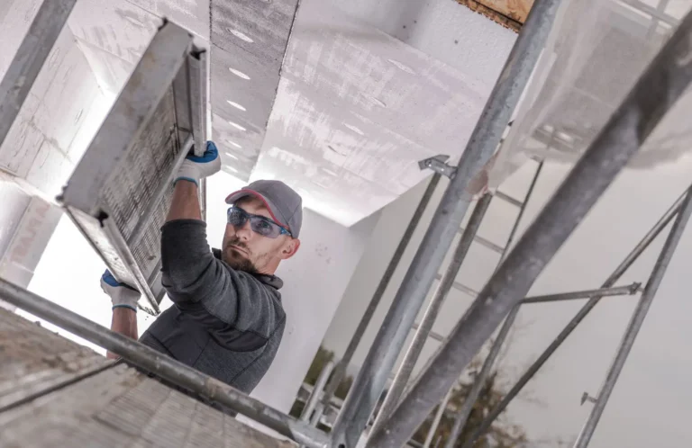 Worker installing scaffold plank system with Glendale Scaffolding Rental equipment